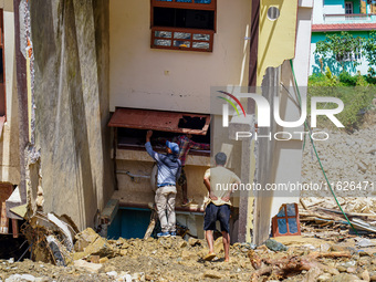 People search for their belongings in damaged houses after Nakhu River flooding in the Tikabhairab region of southern Lalitpur, Nepal, on Oc...