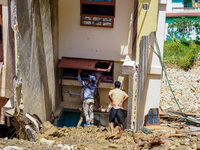 People search for their belongings in damaged houses after Nakhu River flooding in the Tikabhairab region of southern Lalitpur, Nepal, on Oc...