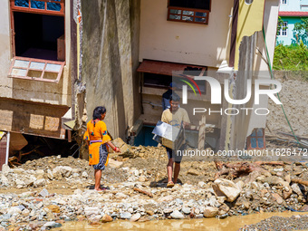 People search for their belongings in damaged houses after Nakhu River flooding in the Tikabhairab region of southern Lalitpur, Nepal, on Oc...