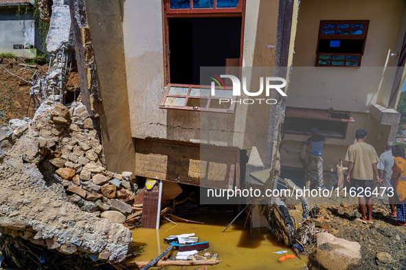 People search for their belongings in damaged houses after Nakhu River flooding in the Tikabhairab region of southern Lalitpur, Nepal, on Oc...