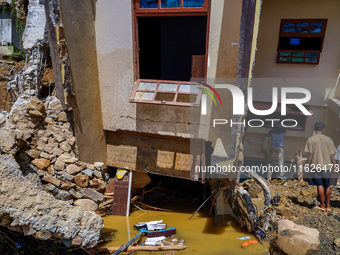 People search for their belongings in damaged houses after Nakhu River flooding in the Tikabhairab region of southern Lalitpur, Nepal, on Oc...