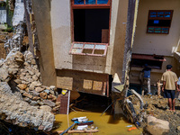 People search for their belongings in damaged houses after Nakhu River flooding in the Tikabhairab region of southern Lalitpur, Nepal, on Oc...