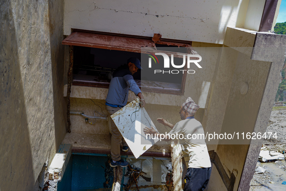 People search for their belongings in damaged houses after Nakhu River flooding in the Tikabhairab region of southern Lalitpur, Nepal, on Oc...