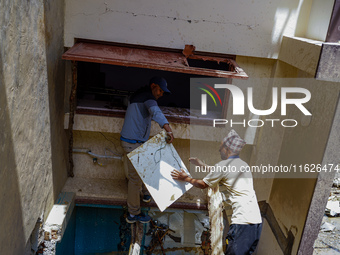 People search for their belongings in damaged houses after Nakhu River flooding in the Tikabhairab region of southern Lalitpur, Nepal, on Oc...