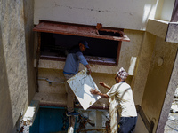 People search for their belongings in damaged houses after Nakhu River flooding in the Tikabhairab region of southern Lalitpur, Nepal, on Oc...