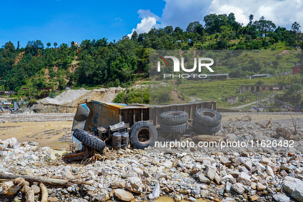 The Nakhu River flooding sweeps and damages a vehicle in the Tikabhairab region of southern Lalitpur, Nepal, on October 1, 2024. 