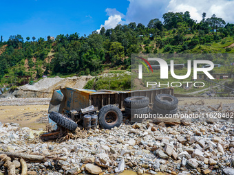 The Nakhu River flooding sweeps and damages a vehicle in the Tikabhairab region of southern Lalitpur, Nepal, on October 1, 2024. (