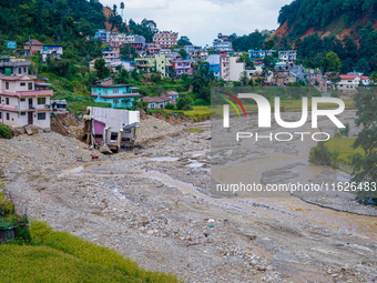 Nakhu River flooding damages homes in the Tikabhairab region of southern Lalitpur, Nepal, on October 1, 2024. Homes are severely damaged, wi...