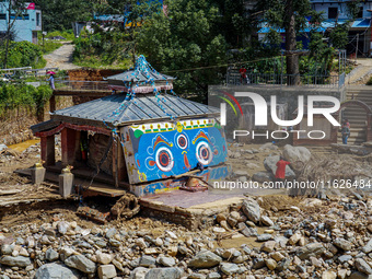 The Nakhu River flooding damages a temple in the Tikabhairab region of southern Lalitpur, Nepal, on October 1, 2024. Homes are severely dama...