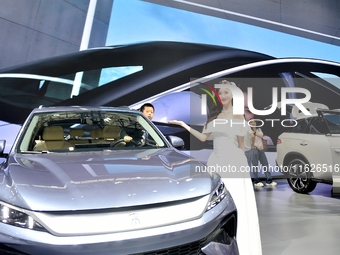 People visit the 2024 Hefei International New Energy Vehicle Exhibition in Hefei, China, on October 1, 2024. (