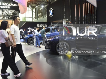 People visit the 2024 Hefei International New Energy Vehicle Exhibition in Hefei, China, on October 1, 2024. (