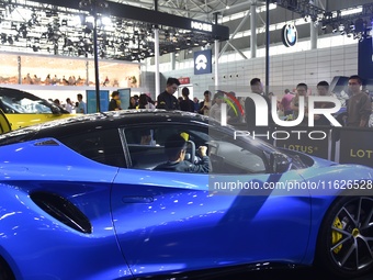 People visit the 2024 Hefei International New Energy Vehicle Exhibition in Hefei, China, on October 1, 2024. (