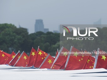 The five-star red flags fly in the wind on the West Lake cruise boat to celebrate the 75th anniversary of the founding of the People's Repub...