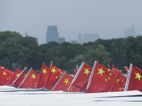 The five-star red flags fly in the wind on the West Lake cruise boat to celebrate the 75th anniversary of the founding of the People's Repub...