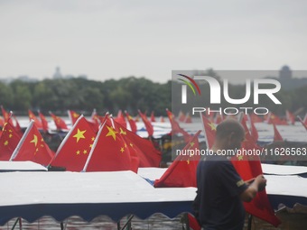 The five-star red flags fly in the wind on the West Lake cruise boat to celebrate the 75th anniversary of the founding of the People's Repub...