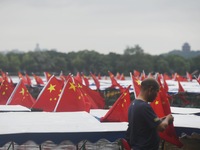 The five-star red flags fly in the wind on the West Lake cruise boat to celebrate the 75th anniversary of the founding of the People's Repub...