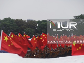 The five-star red flags fly in the wind on the West Lake cruise boat to celebrate the 75th anniversary of the founding of the People's Repub...