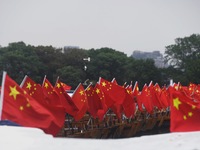 The five-star red flags fly in the wind on the West Lake cruise boat to celebrate the 75th anniversary of the founding of the People's Repub...