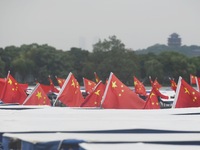 The five-star red flags fly in the wind on the West Lake cruise boat to celebrate the 75th anniversary of the founding of the People's Repub...