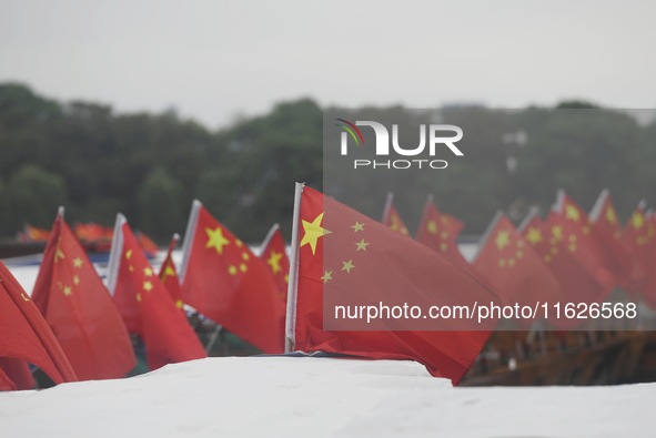 The five-star red flags fly in the wind on the West Lake cruise boat to celebrate the 75th anniversary of the founding of the People's Repub...