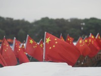 The five-star red flags fly in the wind on the West Lake cruise boat to celebrate the 75th anniversary of the founding of the People's Repub...