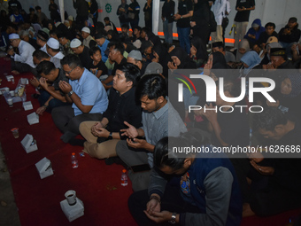 Hundreds of soccer supporters and families of the victims of the Kanjuruhan Stadium disaster hold a joint prayer at Gate 13 of Kanjuruhan St...