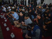 Hundreds of soccer supporters and families of the victims of the Kanjuruhan Stadium disaster hold a joint prayer at Gate 13 of Kanjuruhan St...