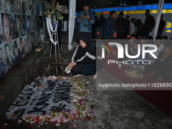 Hundreds of soccer supporters and families of the victims of the Kanjuruhan Stadium disaster hold a joint prayer at Gate 13 of Kanjuruhan St...