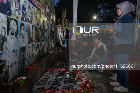 Victims' families cry during a prayer vigil on the second anniversary of the football disaster that kills 135 people on October 1, 2022, at...