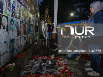 Victims' families cry during a prayer vigil on the second anniversary of the football disaster that kills 135 people on October 1, 2022, at...