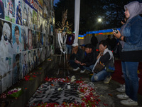 Victims' families cry during a prayer vigil on the second anniversary of the football disaster that kills 135 people on October 1, 2022, at...