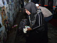 Victims' families cry during a prayer vigil on the second anniversary of the football disaster that kills 135 people on October 1, 2022, at...