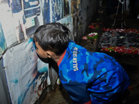 A child kisses a poster of his father during a prayer vigil to mark the second anniversary of the football disaster that killed 135 people o...