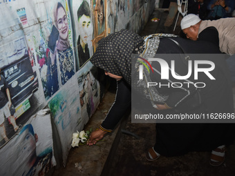 Hundreds of soccer supporters and families of the victims of the Kanjuruhan Stadium disaster hold a joint prayer at Gate 13 of Kanjuruhan St...