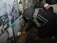 Hundreds of soccer supporters and families of the victims of the Kanjuruhan Stadium disaster hold a joint prayer at Gate 13 of Kanjuruhan St...