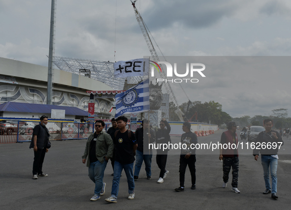 Hundreds of Arema FC supporters march to Kanjuruhan Stadium to mark the second anniversary of the football disaster that killed 135 people....