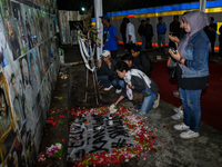 Victims' families cry during a prayer vigil on the second anniversary of the football disaster that kills 135 people on October 1, 2022, at...