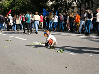 A child plays with leaves in a procession of the demonstration against the policies of Michel Barnier and Emmanuel Macron, in Paris, France,...