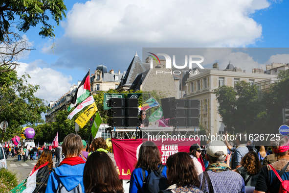 A DJ from Action Justice Climat leads a procession during the interprofessional strike day against the policies of Michel Barnier and Emmanu...