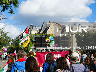 A DJ from Action Justice Climat leads a procession during the interprofessional strike day against the policies of Michel Barnier and Emmanu...