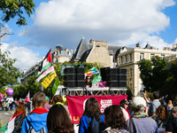 A DJ from Action Justice Climat leads a procession during the interprofessional strike day against the policies of Michel Barnier and Emmanu...