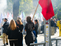 Young demonstrators with a red flag during the interprofessional strike day against the policies of Michel Barnier and Emmanuel Macron, in P...