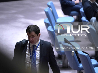 Russian First Deputy Permanent Representative to the UN Dmitry Polyansky exits during a Security Council meeting on migrant smuggling off th...