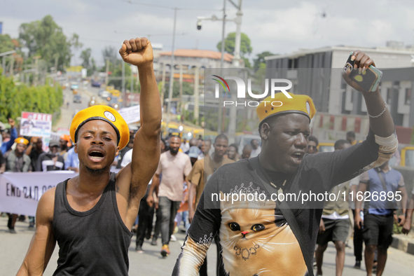 Activists stage a protest tagged #FearlessInOctober over increased hunger, insecurity, and economic hardship as Nigeria marks its 64th Indep...