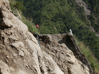 A section of BP Highway, a major highway that connects Kathmandu directly with the Southern Plains of Nepal, is damaged by a landslide in Ka...