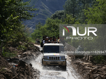 Nepali passengers ride on a jeep as they travel through the partially damaged BP Highway in Kavrepalanchowk District of Central Nepal on Oct...