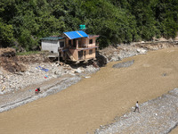 A house sustains damage from flooding in Kavrepalanchowk District along the BP Highway of Nepal, on October 1, 2024. (