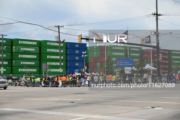 Longshoremen carry signs and demonstrate outside the APM terminals in Elizabeth, New Jersey, United States, on October 1, 2024, as members o...