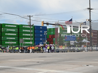 Longshoremen carry signs and demonstrate outside the APM terminals in Elizabeth, New Jersey, United States, on October 1, 2024, as members o...