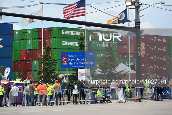 Longshoremen carry signs and demonstrate outside the APM terminals in Elizabeth, New Jersey, United States, on October 1, 2024, as members o...